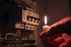 Burning candle near the electrical fuses.
